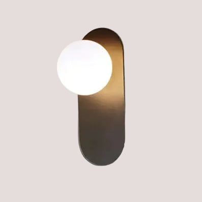 Art Deco Golden Circle Sconce with round light and sleek design on a minimalist background.