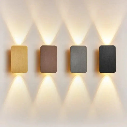 Brushed Gold/Black Double Head Wall Light in four finishes: gold, brown, grey, and black on a light wall.
