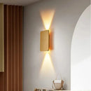 Brushed Gold/Black Double Head Wall Light illuminating a modern interior with elegant up-and-down light beams.