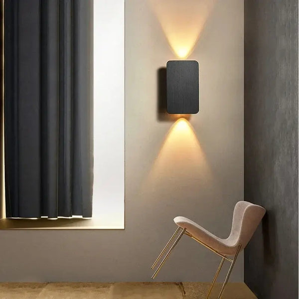 Brushed Gold/Black Double Head Wall Light illuminating a modern interior with warm LED light.