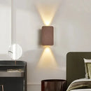 Brushed Gold/Black Double Head Wall Light illuminating a modern bedroom with elegant up-and-down light beams.