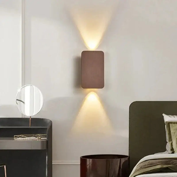 Brushed Gold/Black Double Head Wall Light illuminating a modern bedroom with elegant up-and-down light beams.