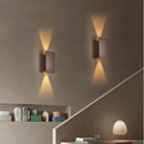 Brushed Gold/Black Double Head Wall Light illuminating a modern interior with stylish up-and-down light beams.