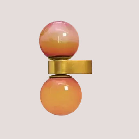 Chic Dual Bubble Wall Light - Modern & Versatile Lighting with colorful globes and polished brass details.
