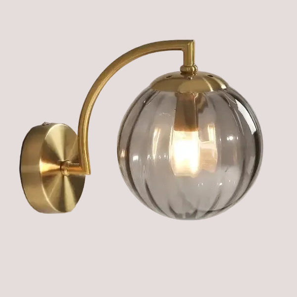 Colourful Glass Modern Wall Light featuring a golden metal base and a colorful transparent bulb.