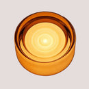 Futuristic and Unique Solid Plexiglass Wall Light in a round amber design, showcasing its warm glow and modern style.
