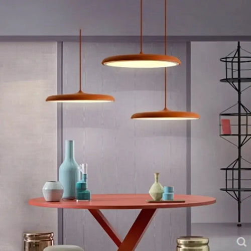 Minimalist Metal Hanging Lamp over a modern table with colorful vases and contemporary decor.