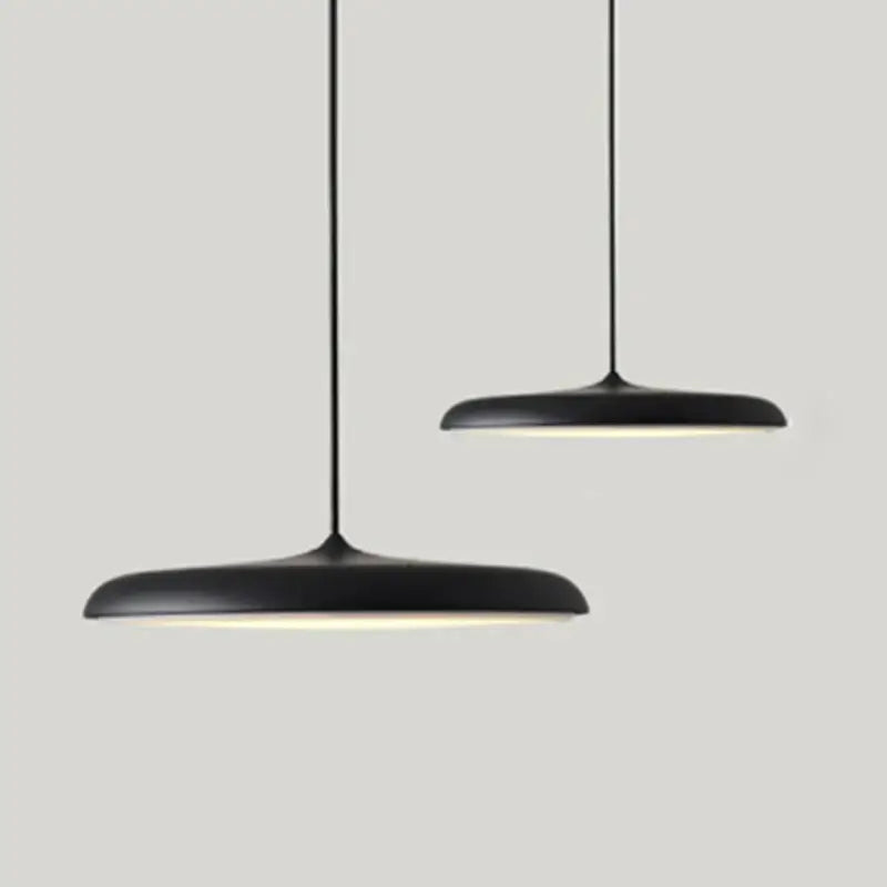 Minimalist Metal Hanging Lamp in black with soft glow, perfect for contemporary home decor.