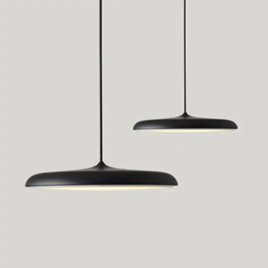 Minimalist Metal Hanging Lamp in black with soft glow, perfect for contemporary home decor.