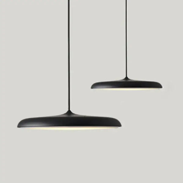 Minimalist Metal Hanging Lamp in black with soft glow, perfect for contemporary home decor.