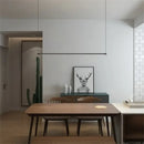 Super Simple Line Lighting | Modern LED Pendant Lamp in a minimalist dining room setting with natural elements.