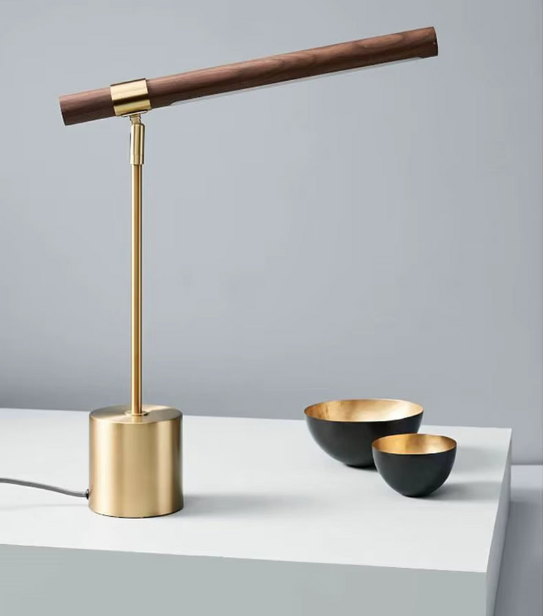 Hero Modern Wood desk lamp with wooden and brass accents on a gray surface.