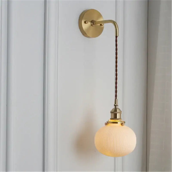 Timeless Elegance: Nordic White Porcelain Wall Lamp with gold mount and soft ambient lighting.