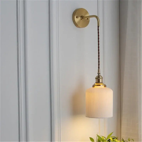 Timeless Elegance: Nordic White Porcelain Wall Lamp featuring a gold mount and soft ambient lighting.