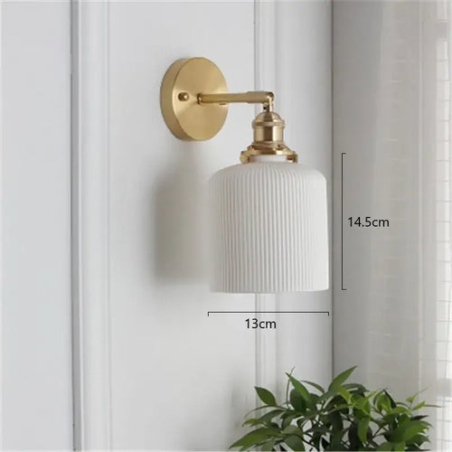 Timeless Elegance: Nordic White Porcelain Wall Lamp displayed on a wall with a gold mount and soft ambient lighting.
