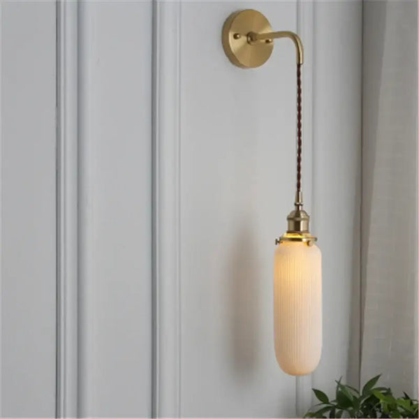 Timeless Elegance: Nordic White Porcelain Wall Lamp showcasing a modern design with a gold mount and soft ambient light.