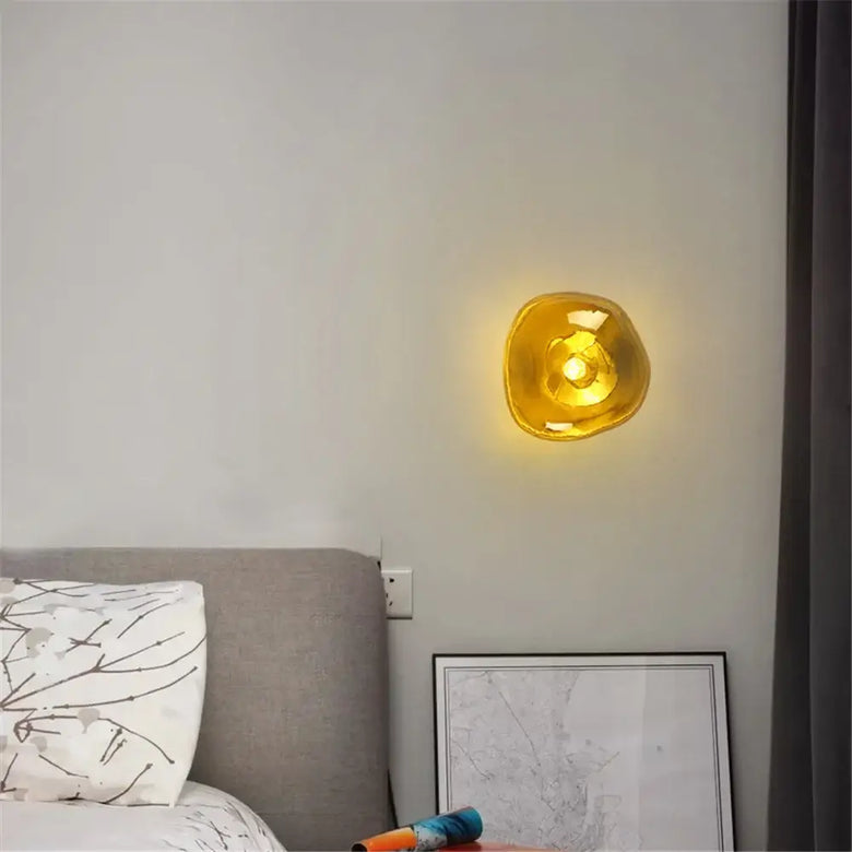 Lava Glass Wall Lamp illuminating a modern bedroom, enhancing decor with its unique design.
