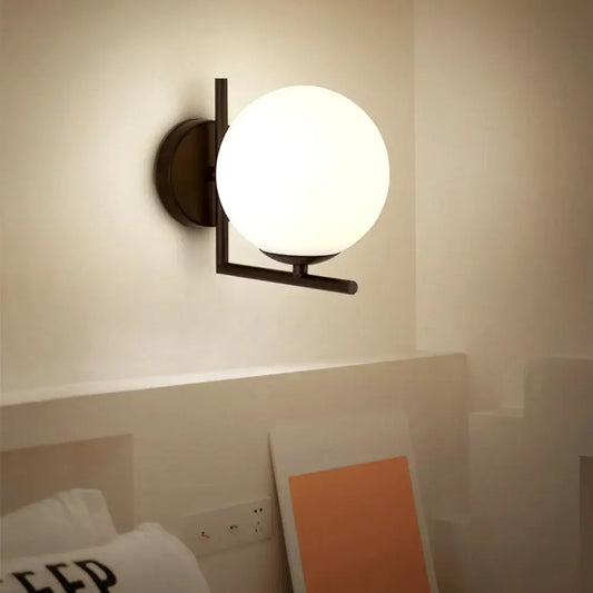 Gold Wall Light featuring a white globe and a sleek modern design suitable for elegant interiors.