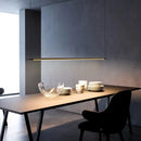 Super Simple Linear Lighting above a modern dining table with minimalist decor and tableware.