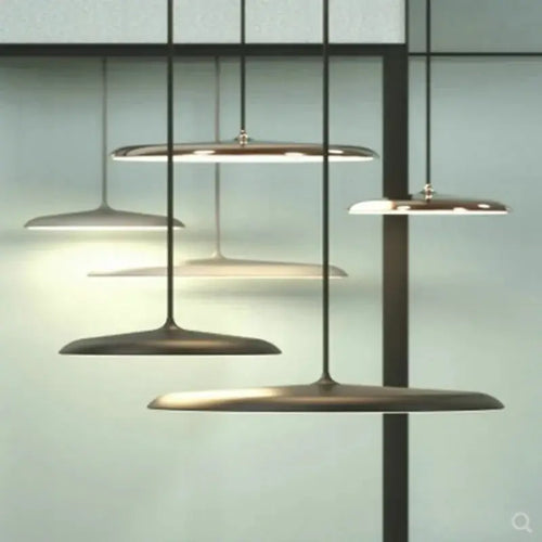 Minimalist Metal Hanging Lamp in contemporary setting with luxurious brass accents and sleek design.