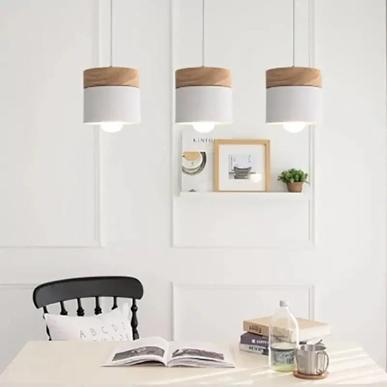 Simple Metal Danish Pendant with Wood in a modern dining room setting, showcasing elegant Nordic design and focused lighting.