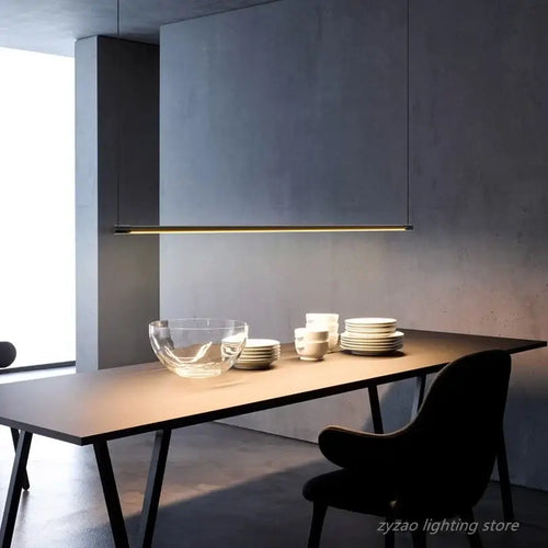 Super Simple Line Lighting | Modern LED Pendant Lamp illuminating a sleek dining table setting.