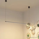 Super Simple Line Lighting | Modern LED Pendant Lamp in minimalist interior setting with mounted wall decor.