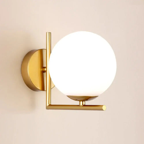 Gold Wall Light with white globe shade providing modern elegance for interior decor.