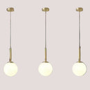Mid-Century Modern Glass Ball Pendant Light trio hanging with brass finish, ideal for stylish interiors.