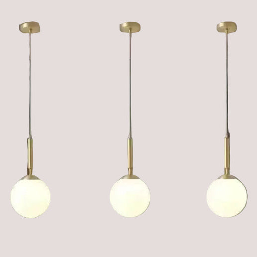 Mid-Century Modern Glass Ball Pendant Light trio hanging with brass finish, ideal for stylish interiors.