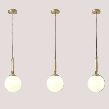Mid-Century Modern Glass Ball Pendant Light trio hanging with brass finish, ideal for stylish interiors.