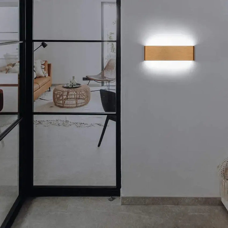 Modern Brushed Gold & Coffee LED Wall Lamp – Sleek Indoor Accent Lighting illuminating a stylish indoor space.