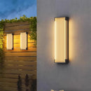 Modern Outdoor Waterproof Stainless Steel Wall Light – Warm & Cool White illuminated on a garden wall.