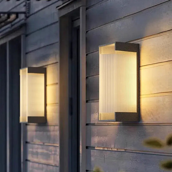 Modern Outdoor Waterproof Stainless Steel Wall Light – Warm & Cool White illuminating a house exterior.