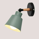 Nordic Solid Wood Bedroom Wall Lamp with sleek iron finish and playful design.