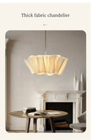 Off-White Pendant Light made from Natural Plant Fiber hanging above a dining table in an elegant interior.