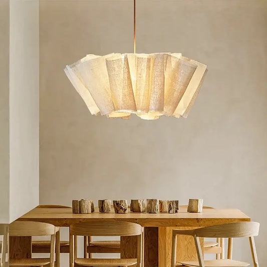 Off-White Pendant Light made from Natural Plant Fiber illuminating a wooden dining table in a serene interior.
