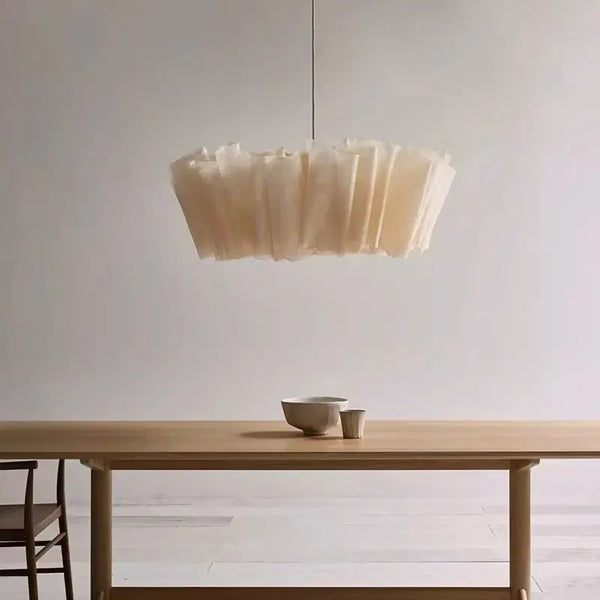 Off-White Pendant Light made from Natural Plant Fiber hanging above a wooden dining table.
