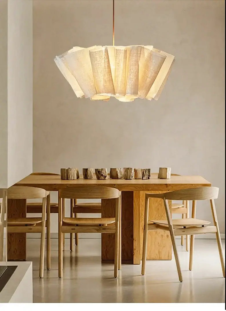 Off-White Pendant Light made from Natural Plant Fiber illuminating a dining space with wooden furniture.