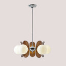 Rare Mid-Century Orange Plexiglass Chandelier: A Unique Vintage Gem with amber/brown reflectors and white frosted glass balls.