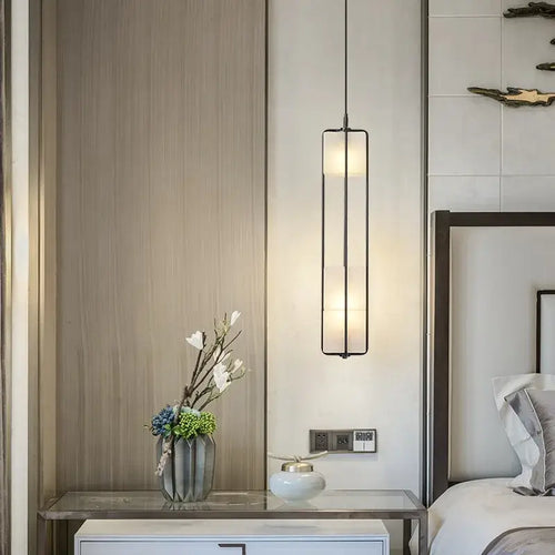 White Glass & Metal Art Deco Chandelier illuminating a stylish bedroom with elegant decor.