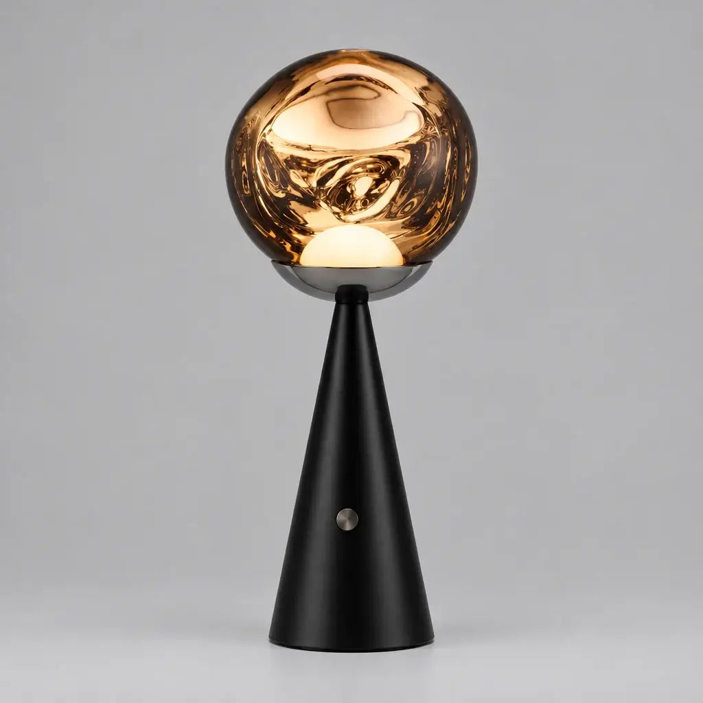 Hero Cordless Lava able lamp with a glossy, reflective metallic gold globe shade on a black cone base, 