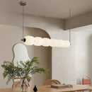 Nordic Art Deco Linear LED Pendant Light – Sculptural Acrylic & Iron Chandelier in a modern dining space.