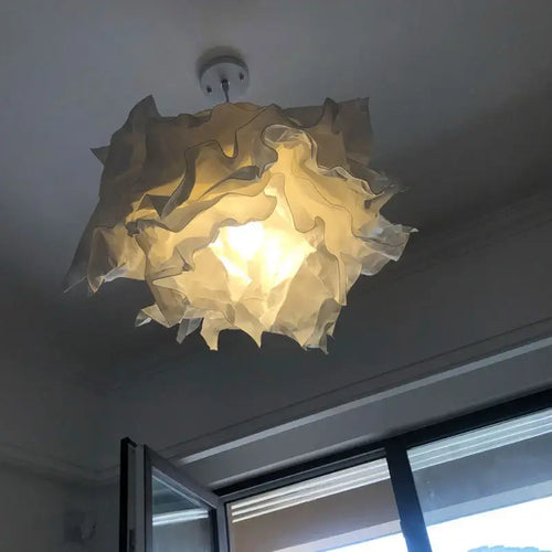 Cloud Like Paper Lamp Shade up to 70cm wide hanging from ceiling, casting warm light in airy interior.