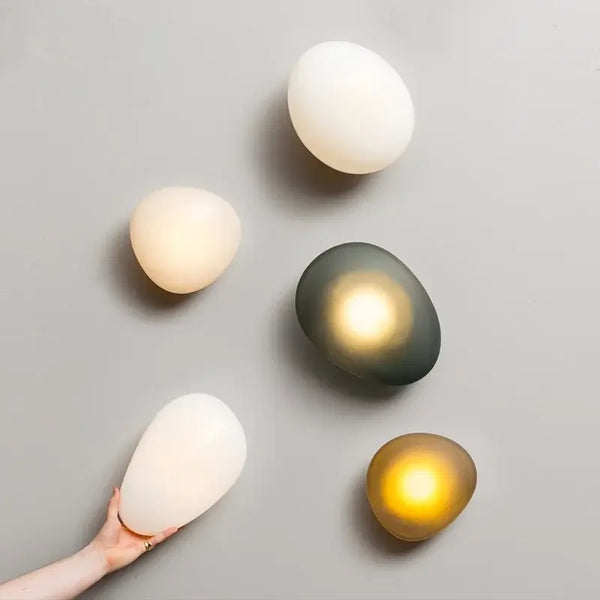 Elegant Frosted Glass Pebble Wall Lamp - Minimalist Nordic Style displayed with different lighting effects.