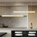 Natural Marble Linear Pendant Light 80–120cm hanging over a modern kitchen island with a sleek design.