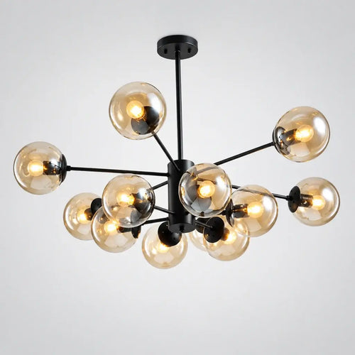 A modern multi-light chandelier with clear glass spherical bulbs and a matte black metal frame, shown hanging from the ceiling in a contemporary interior space.