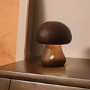 Portable Dimmable 60s Italy Designer Mushroom Table Lamp on a wooden table, showcasing its modern design and warm light.