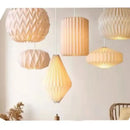 Elegant Origami-Inspired Paper Lantern hanging in a cozy, modern interior, showcasing beautiful lighting and design.