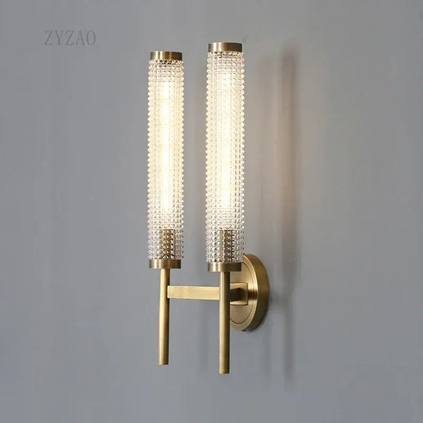 Stylish Art Deco Brass Wall Lamp featuring frosted glass and a warm white glow on a modern wall.